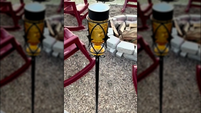 Image of a vintage drinking glass in a DIY solar tiki torch.