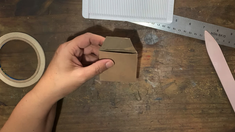 Person showing a cardboard seed envelope DIY