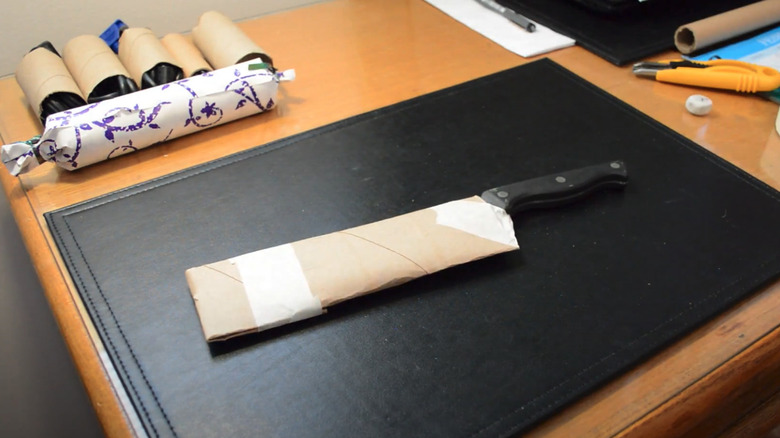 Desk top with a kitchen knife and sheath