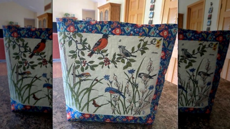 Zippered storage pouch made out of a vintage dish towel with birds and branch design.