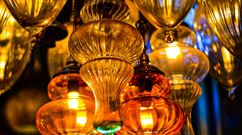 A closeup of vintage colored glass lights hanging from ceiling.