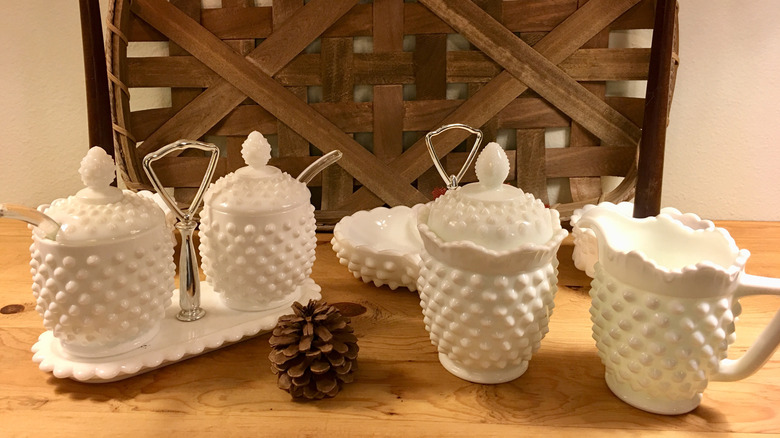Pieces of vintage milk glass on a table