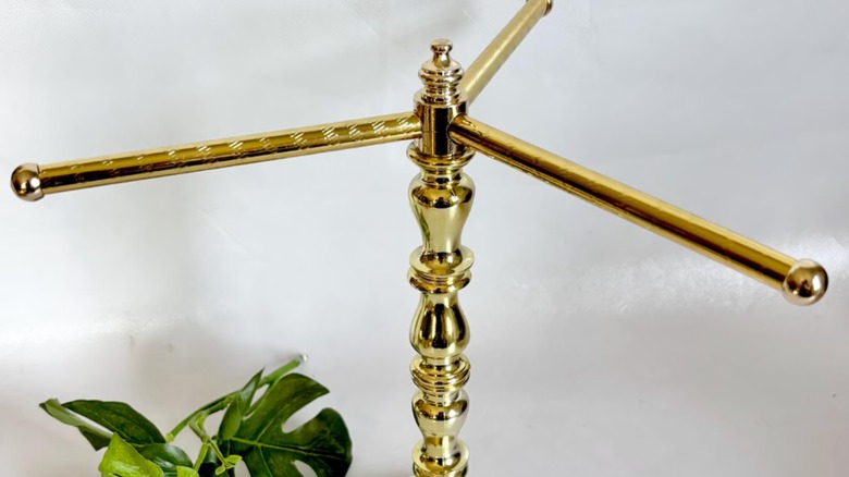 golden three-armed towel holder