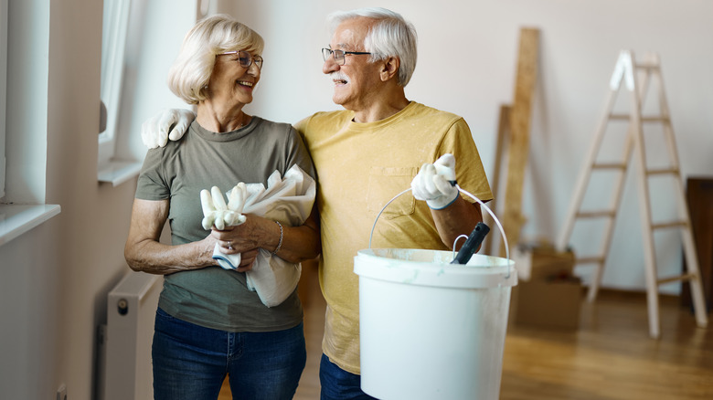 elderly couple with paint bucket