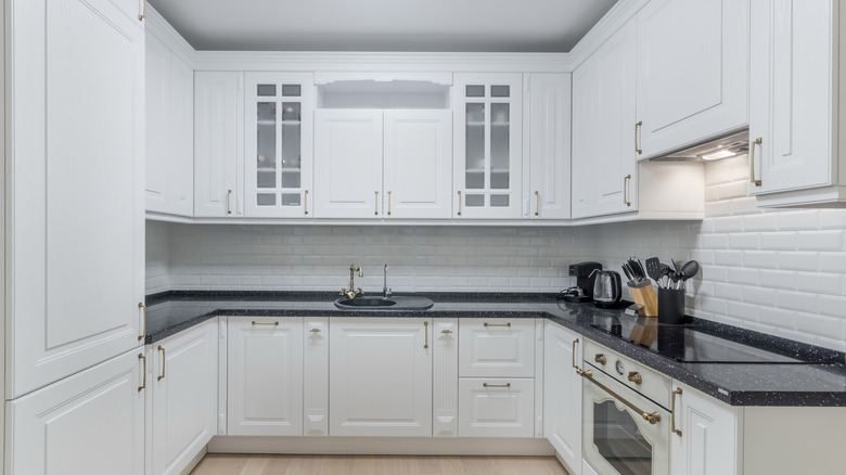 Bright and airy kitchen with glass cabinet inserts on some of the upper cabinets