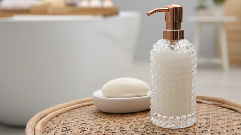 A stylish glass dispenser in a bathroom.
