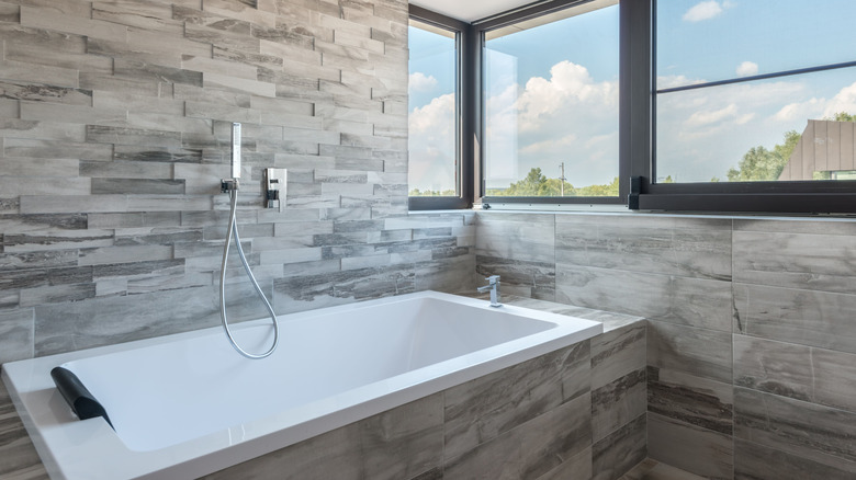 A built-in tub surrounded by stacked stone