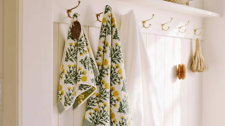 Floral patterned towels on hooks