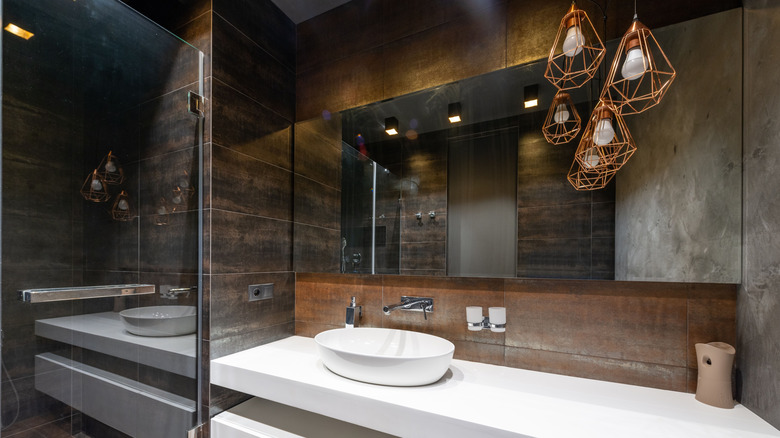A bathroom with layered light fixtures