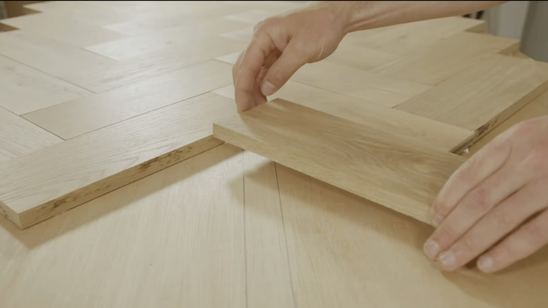 Laying wood planks to create a herringbone tabletop