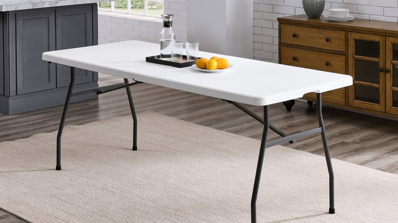 A basic folding table in use in a kitchen