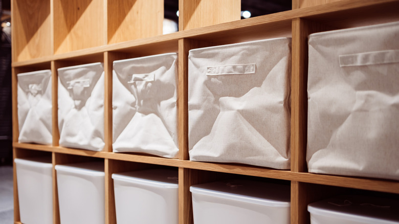 Row of boring, plain white fabric storage cubes.
