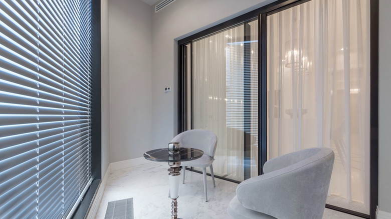 sliding glass door leads to enclosed indoor patio