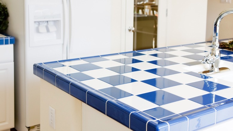 Blue and white tiled kitchen countertop with sink