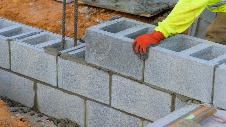 A plain retaining wall made from concrete blocks.