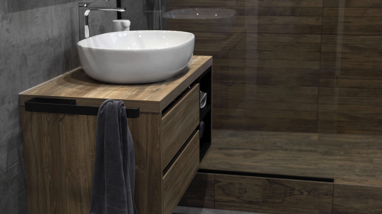 A modern bathroom with a floating wood vanity.