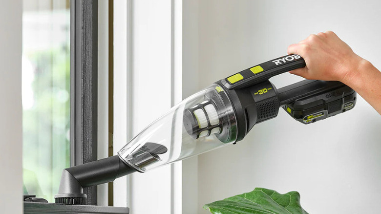 Close-up of a person's hand as they use the Limited Edition 18V One+ Performance Hand Vacuum