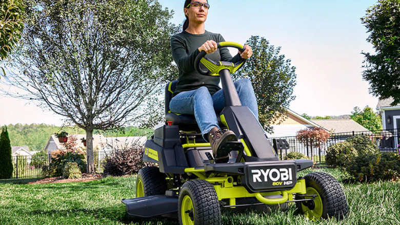 A person riding the R1 80V HP Brushless 30-inch Riding Lawn Mower Kit