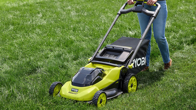 A person mowing the lawn with Ryobi's 40V HP Brushless 20-inch Self-Propelled Mower Kit