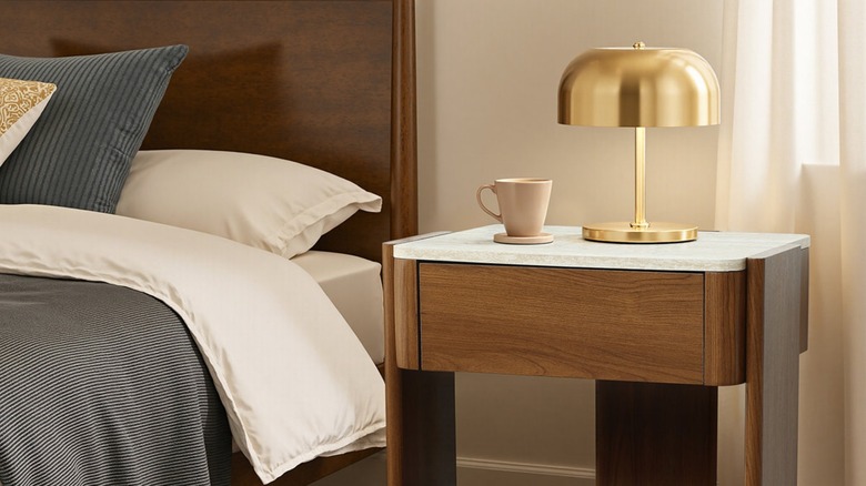 Dark brown nightstand with white stone top.