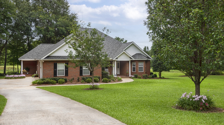 nice brick home with a long driveway