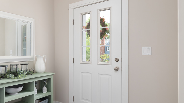 Small entryway with slim green shelf to the left