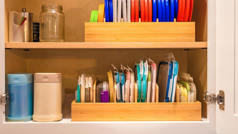 Bamboo organizer for plastic lids in kitchen cabinet