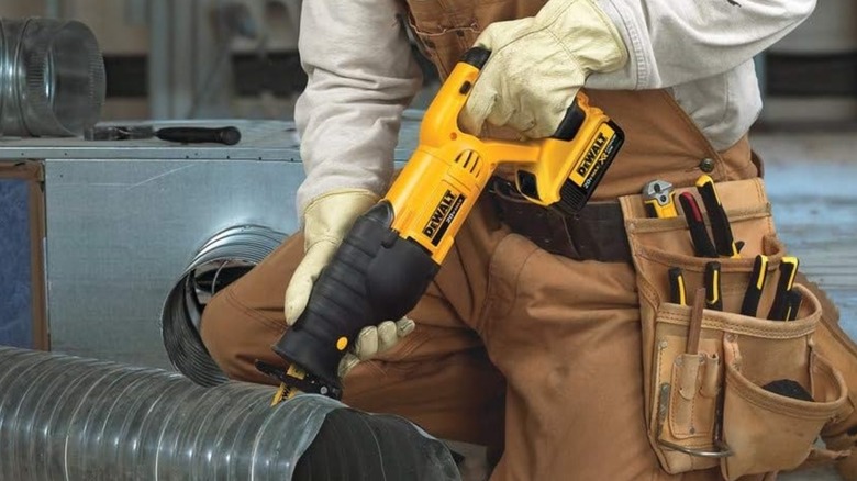 DeWalt 20V MAX Cordless Reciprocating Saw being used to cut ducting