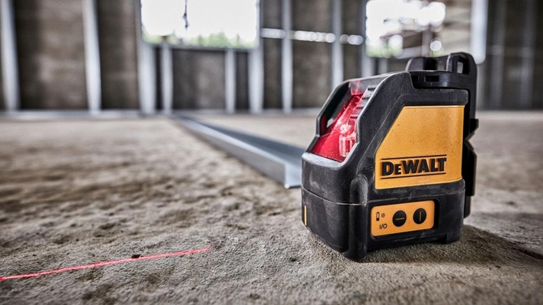 DeWalt Self-Leveling Line Laser being used on the floor of an unfinished building
