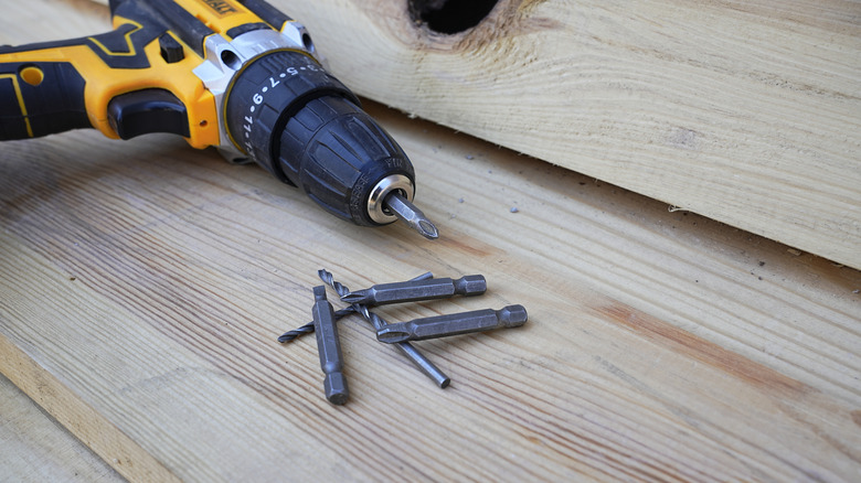 DeWalt drill and bits on wood planks