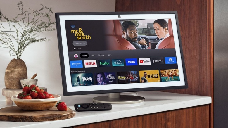 Amazon Echo Show on a stand sitting on a counter with berries