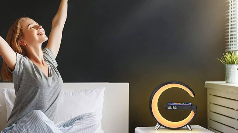 Bluetoothspeaker and charger on a table with a girl waking up in the morning