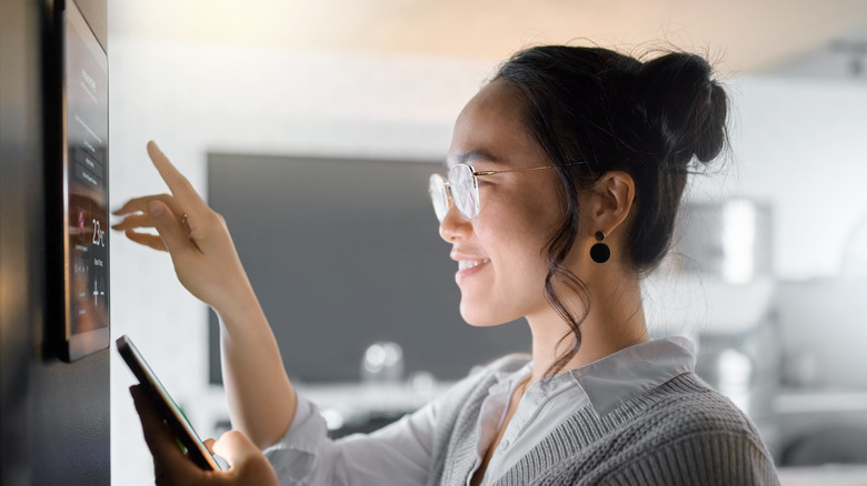 young woman using a tablet for home automation