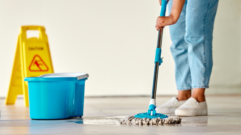 person mopping the floor