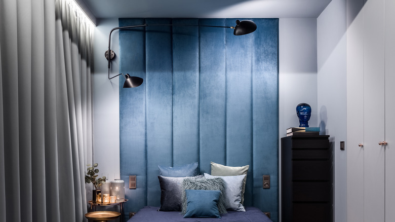 Bedroom with blue upholstery wall