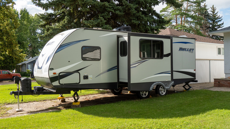 a travel trailer set up in a neighborhood