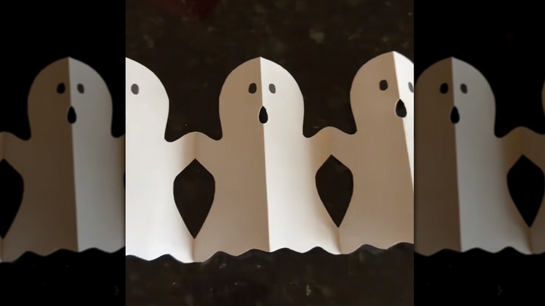 A completed ghost garland made from white paper