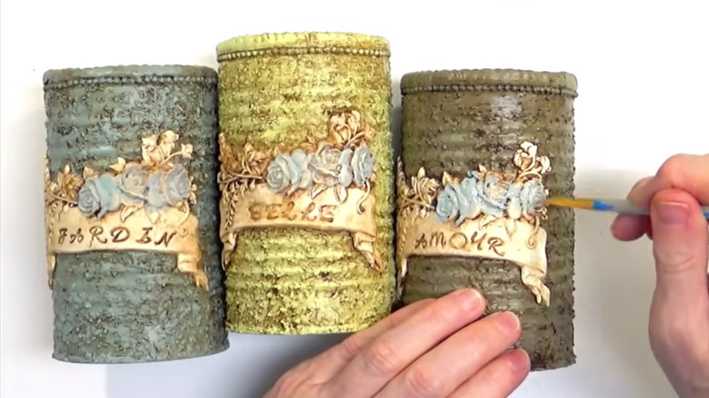 Painting soup cans with old-fashioned decorations