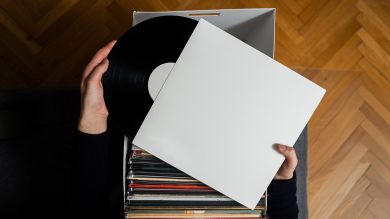 Person looking through a box of vinyl records