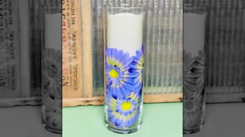 A candleholder supported by a pool noodle