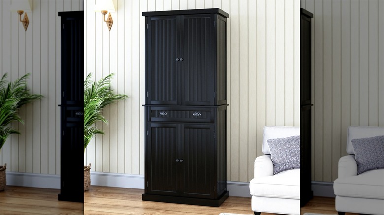 A black pantry cabinet in a living room