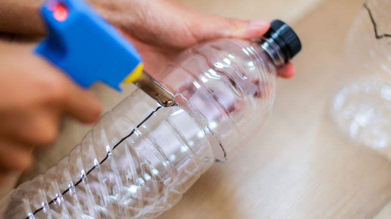 A plastic bottle being used for a crafting project