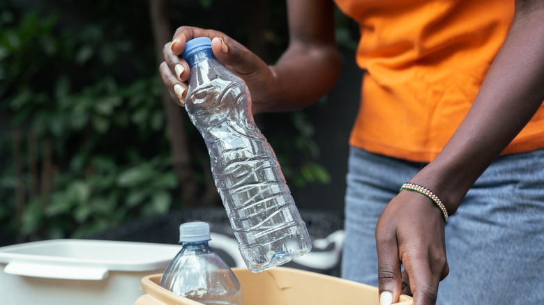 Woman holding plastic bottle
