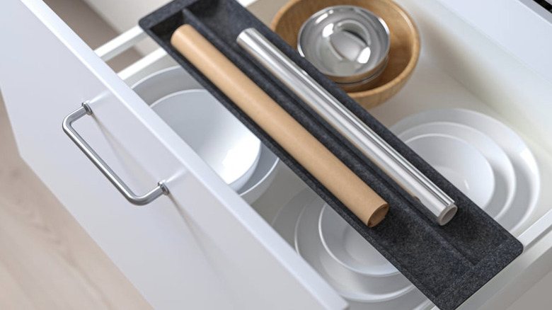 IKEA UPPDATERA Sliding organizer for drawer in kitchen drawer holding rolls of foil and parchment