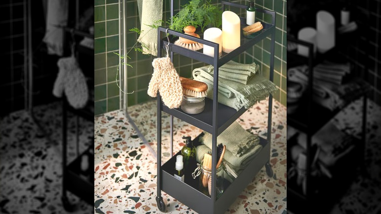 NISSAFORS black cart used in a bathroom to hold shower items.