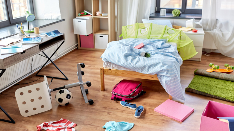 Messy kid's room with toys and clothes on the floor