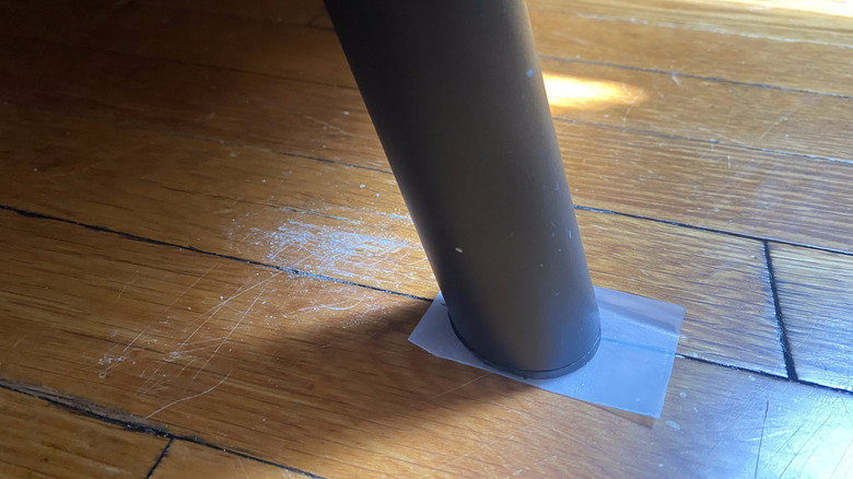 A slip of plastic under a couch leg