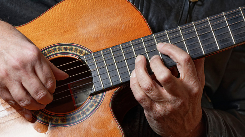 Closeup of someone playing a classical guitar