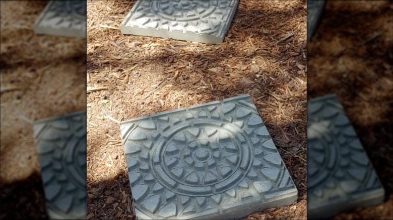 Stepping stones made with a design from a rubber doormat on mulch