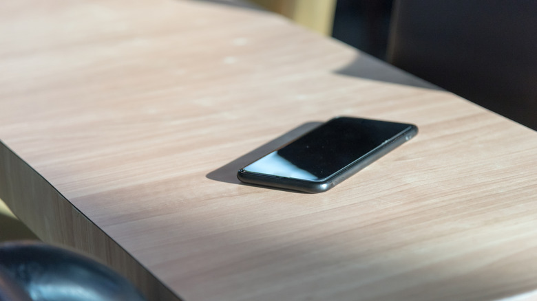 A smartphone kept on a wood table